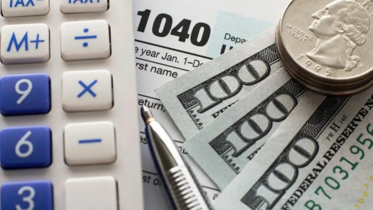 How to Add New Tax Debt to Payment Plan - Money laying on table next to a calculator