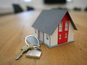 Can the IRS Take my Home? Blog featured image with mini house sitting on table next to house key