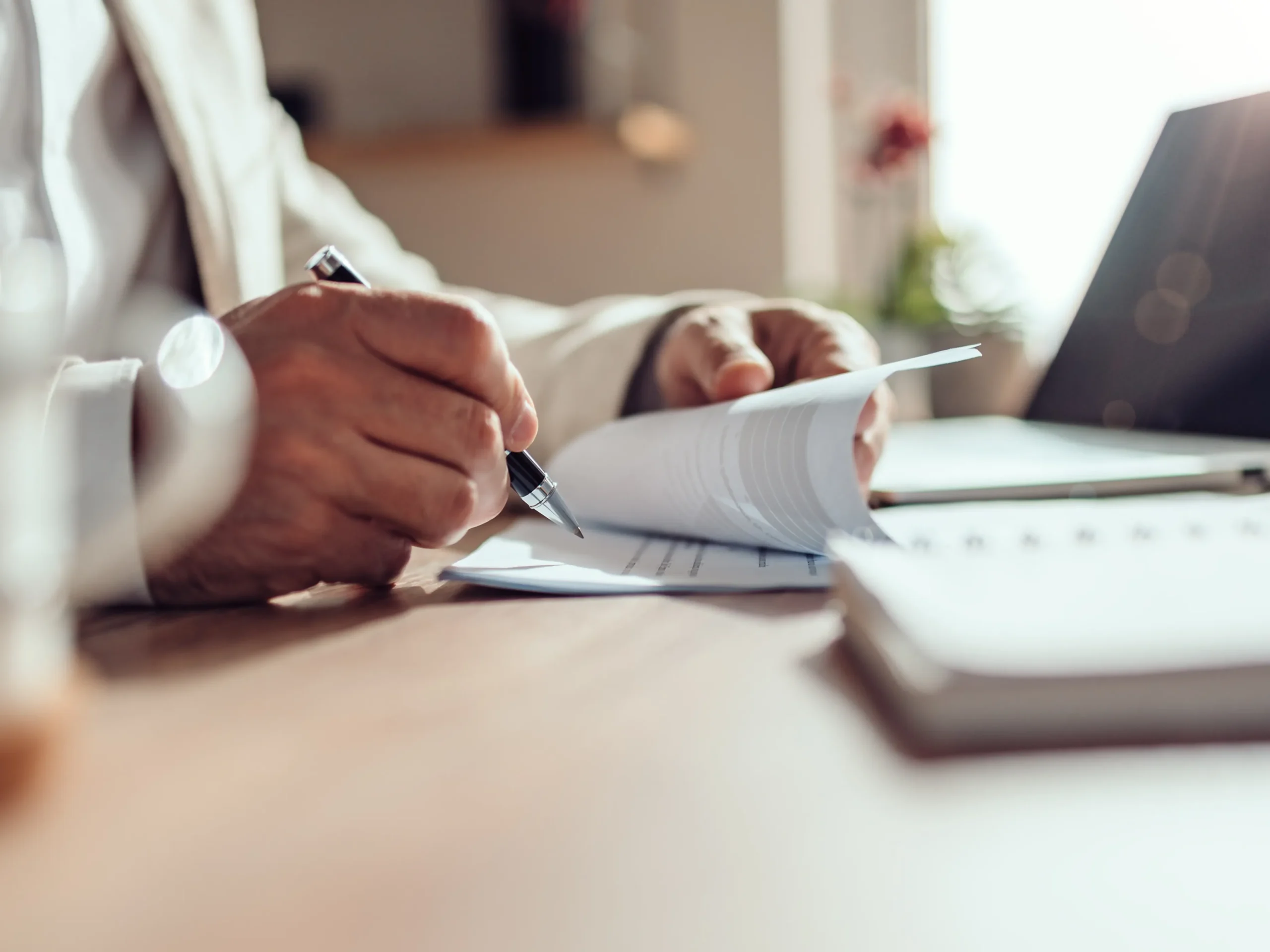 person filing their end-of-year taxes on a desk