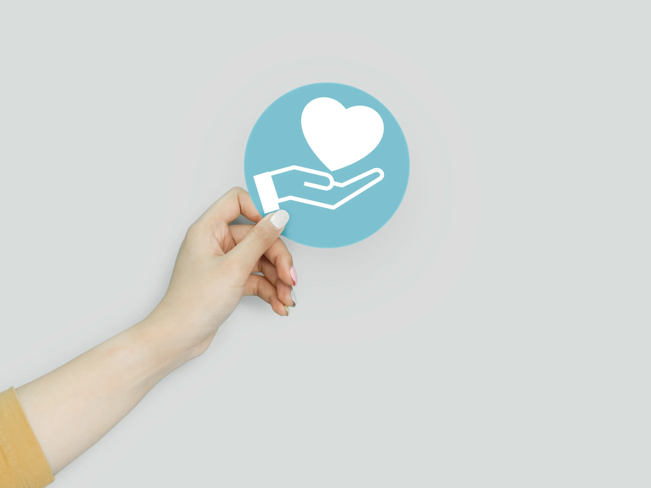 charitable contributions - hand holding a picture of a graphic that implies giving to charity