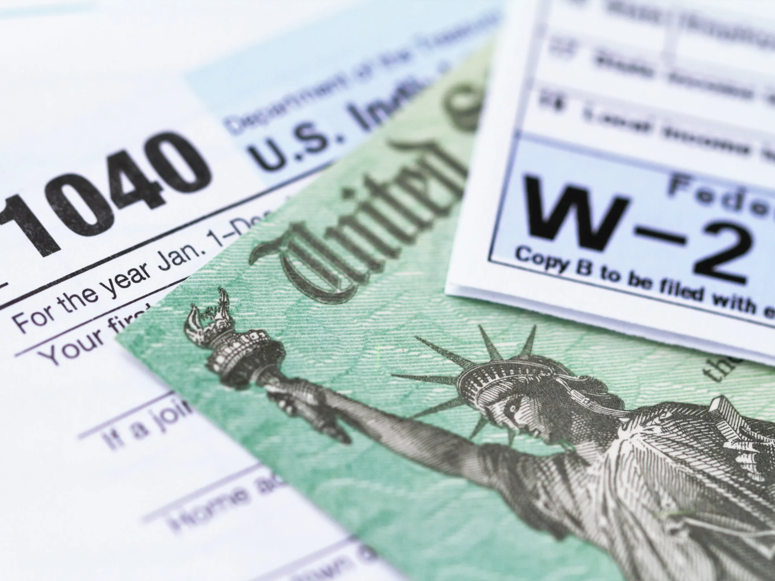 1040, W-2, and Currency - papers to have when considering end-of-year tax tips