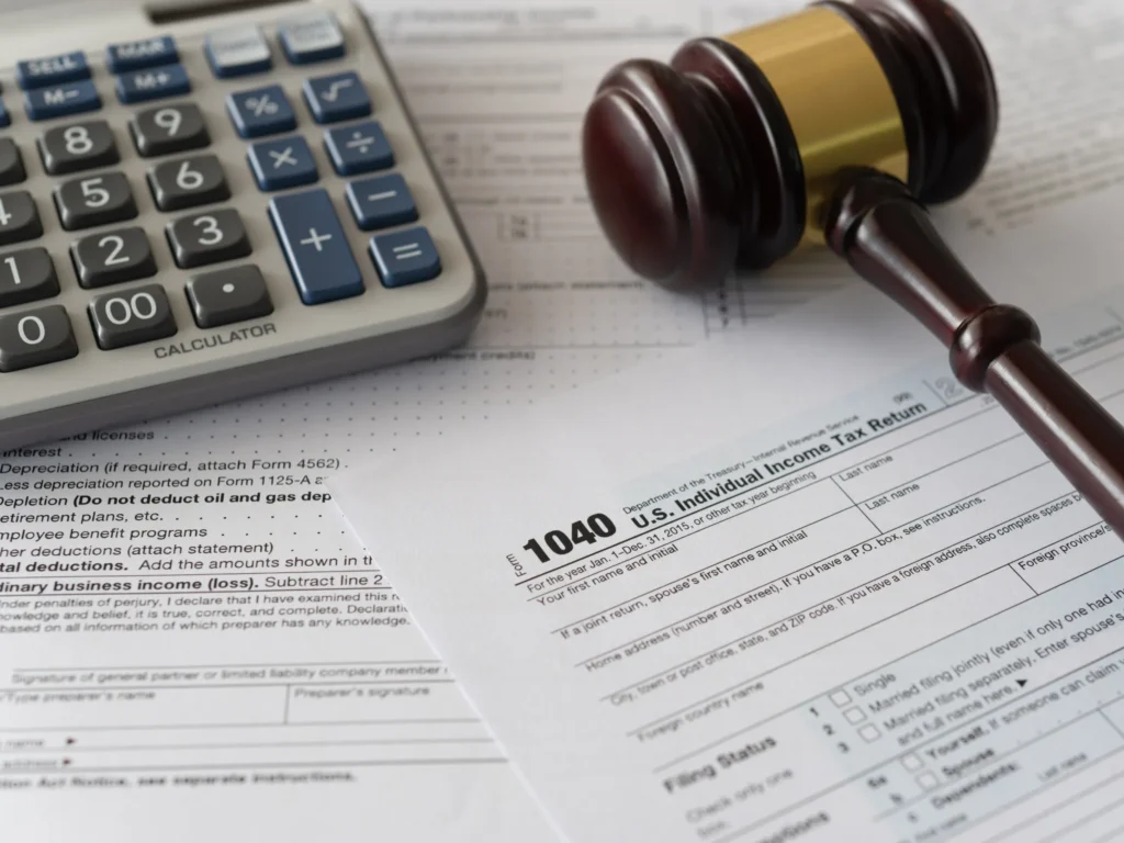 gavel, 1040 form, and calculator - indicating "What does a tax attorney do?"
