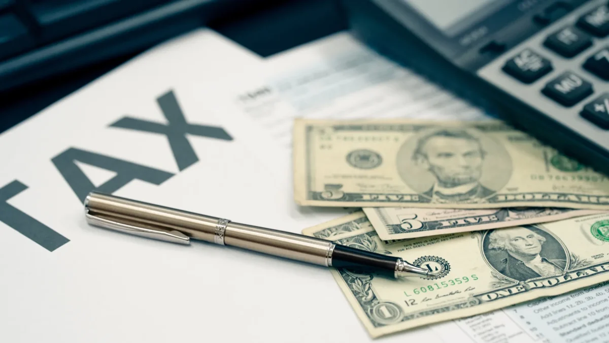 Mistakes to avoid when filing taxes - tax documents with bills and a pen sitting on table