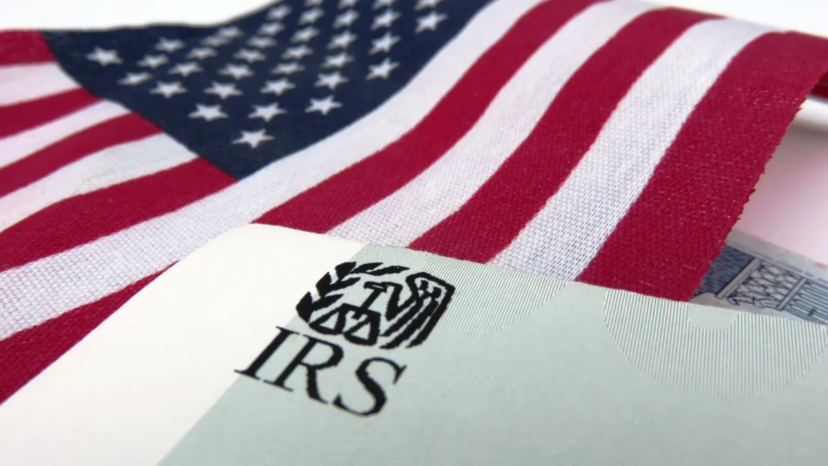 Can the IRS freeze my bank account? - American flag in background with IRS folder in foreground