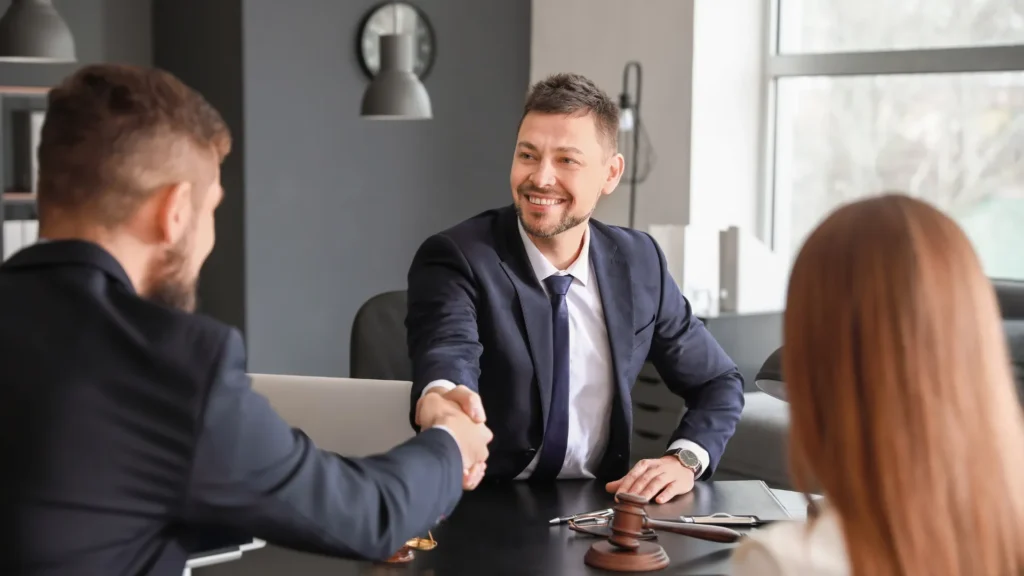 Man shaking hands with a professional tax attorney in his office