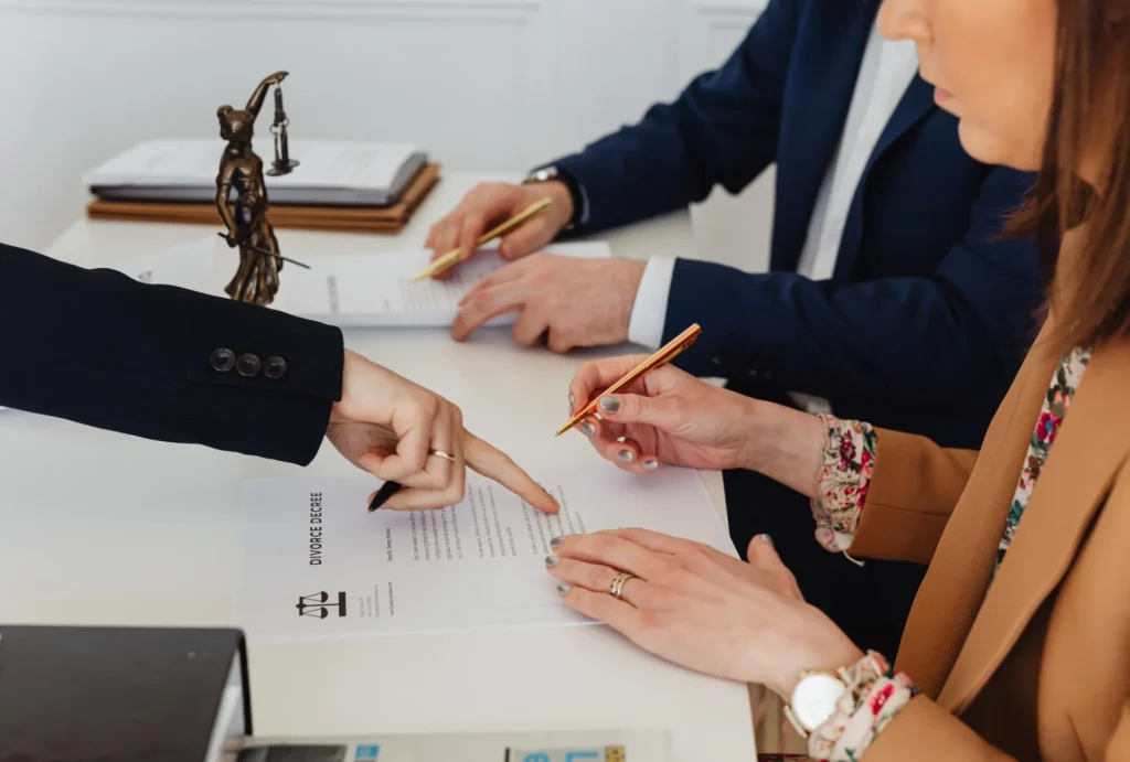 woman in suit being guided to fill out paperwork