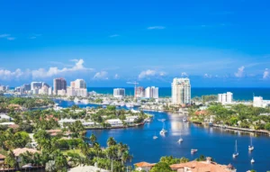 Florida coastline with blue skies, blue water, and palm trees