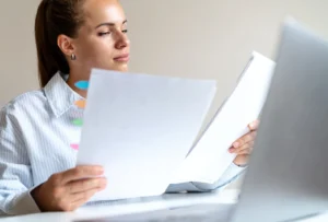 Woman sitting at a table with her laptop open trying to answer "what is a tax holiday?'