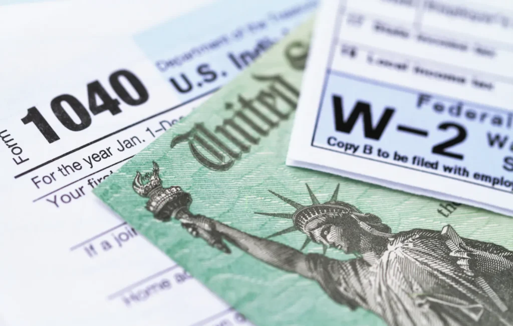 tax document preparation with a 1040 and W-2 sitting on a table